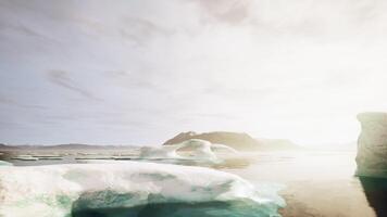 A group of icebergs floating on top of a body of water video