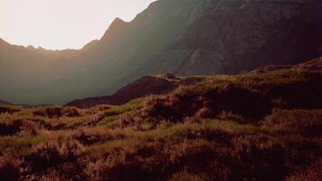 The sun shines on the mountains in the distance. mountain sunset video
