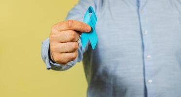 Support for men's health with blue ribbon during cancer awareness campaign photo