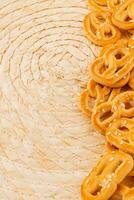 Enjoying fresh sesame pretzels on a rustic woven mat in the afternoon photo