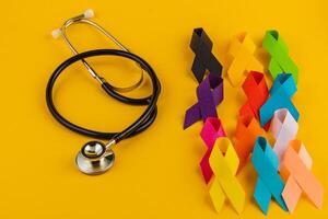 Colorful awareness ribbons and a stethoscope symbolizing health campaigns photo