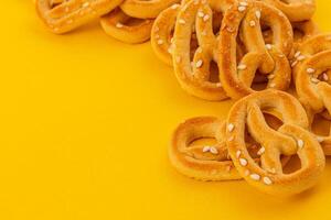 Delicious pretzels on a bright yellow background ready for snacking photo