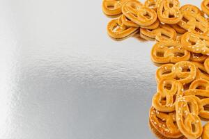 Pretzels arranged on a reflective surface showcasing their golden brown color photo