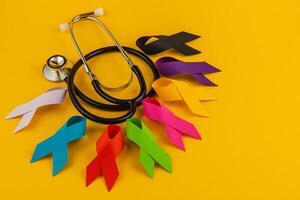 Colorful awareness ribbons and stethoscope representing health campaigns photo