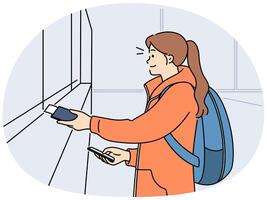 Smiling girl buy tickets at railway station vector