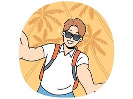 Man tourist in sunglasses takes selfie traveling to hot resort or sunny beach with palm trees vector