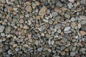 Processed collage of sea shore pebbles texture. Background for banner, backdrop or texture for 3D mapping photo