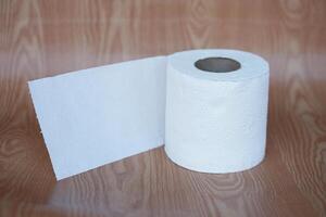 Roll of white toilet paper, on brown background. Concept, cleaning tool, hygienic to wipe dirty and absorb wet ,use tissue paper for hygienic and sanitary in daily life. photo