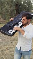 Pianist Man Walks Playing Musical Keyboard On Shoulder In Nature Of Sicily video