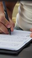 Man Writes Chords On Sheet Music And Study Keyboard video