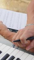 Man Prepares Musical Chords On The Keyboard And Marks The Notes In The Score video