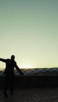 Silhouette Of An Elderly Man Runs Happy With Joy Towards A Wonderful Sunset Sky video