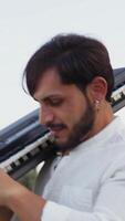 Caucasian Man Walks Playing Musical Keyboard On Shoulder In Nature Of Calabria video