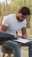 Man Prepares Musical Chords On The Keyboard And Marks The Notes In The Sheet video