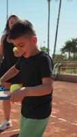 Children Learn Balance With Tennis Racket In Court With Instructor video
