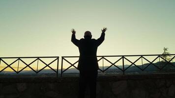 Silhouette Of A Man Greeting Happy With Hand From The Panoramic View Of The City video