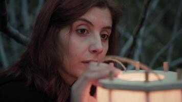 Woman Reflects On The Uncertain Future With A Lantern At Night In Spooky Forest video