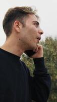 Boy Talks Enthusiastically On The Smartphone In The Park Outside video