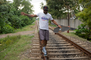 Man Balancing on Train Tracks with Longboard psd