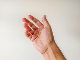 Closeup of a mans hand reaching out against a neutral background. Perfect for concepts of giving, receiving, help, or connection. Ideal for website banners, presentations, or app interfaces. photo