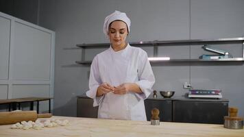 Chef preparing dumpling wrappers on a wooden table video