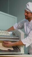 Chef Removing Flattened Dough from Sheeter Machine video