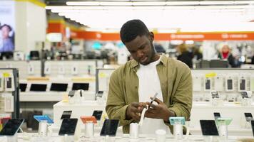 Man testing a new smartphone in an electronics store video