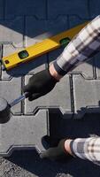 Worker Installing Paving Slabs with Hammer video