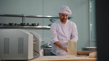 Chef Removing Flattened Dough from Dough Rolling Machine video