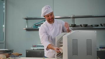 Chef Removing Flattened Dough from Sheeter Machine video