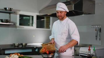 Chef Adding Sliced Tomatoes to a Bowl video