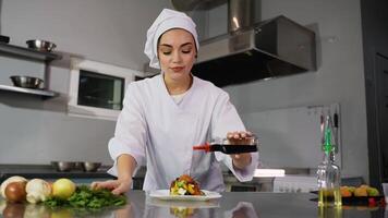 Chef adding balsamic vinegar to a vegetable salad video