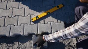 Worker Installing Paving Slabs with Hammer video