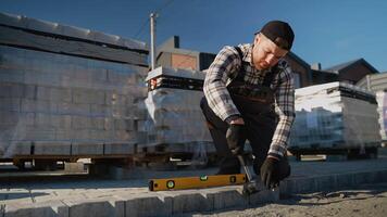 Worker Installing Paving Stones with Hammer video
