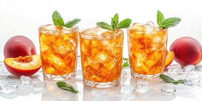 Refreshing peach iced tea served in glasses with ice and mint leaves garnished on a bright surface photo