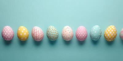 Colorful painted eggs arranged on a soft blue surface for festive spring celebrations photo