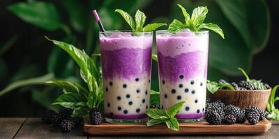 Refreshing bubble tea with layered purple and white flavors served with mint garnish on wooden surface photo