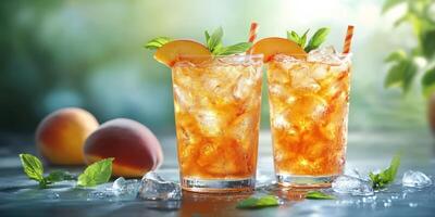 Refreshing peach iced tea served with mint in two glasses on a sunny day photo