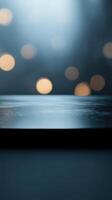 Soft light illuminating a reflective surface with blurred bokeh against a dark background at nighttime photo