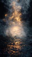 Warm light dances through fog on a dark and wet surface in the early hours of the morning photo