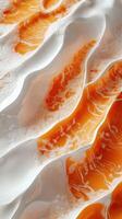 Striking patterns of orange and white sand dunes illuminated by sunlight in a desert landscape during midday photo