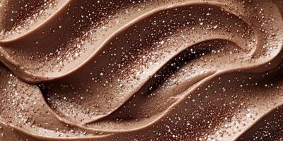 Chocolate frosting swirls with a glossy finish and sparkling accents revealing a rich texture and creamy appearance photo