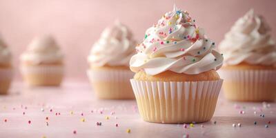 Beautifully decorated cupcakes with colorful sprinkles placed on a pastel surface, perfect for celebrations and treats photo