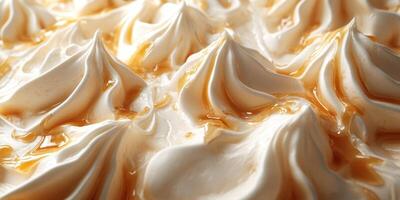 Creamy dessert topped with caramel drizzles highlights intricate meringue peaks in a close-up view during a sunny afternoon photo
