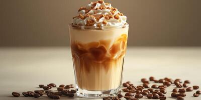 Creamy iced coffee dessert topped with whipped cream and caramel, served in a clear glass with roasted coffee beans scattered around photo