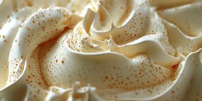 Creamy dessert topping with intricate swirls and golden flecks during an afternoon gathering photo
