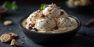 Deliciously creamy ice cream served with crushed cookies and mint on a dark surface photo