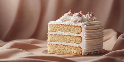 Delicious slice of vanilla cake with creamy frosting on a soft fabric background photo