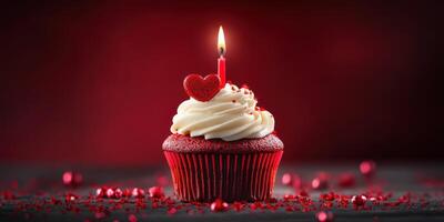 Red velvet cupcake with a heart-shaped decoration and candle on a festive table setting photo