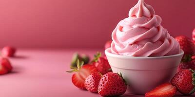 Delicious strawberry soft serve ice cream in a bowl surrounded by fresh strawberries on a pink background photo